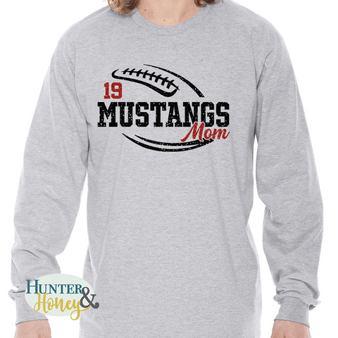 A gray long sleeve t-shirt with a black and red glitter football graphic with Mustangs Mom cutting through the middle of the football and customized with a player's jersey number above Mustangs.