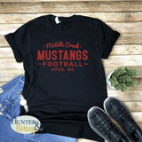 Black 100% cotton t-shirt with red glitter design that reads Middle Creek Mustangs Football Apex, NC.