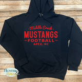 A black hooded fleece sweatshirt with a red HTV design that reads Middle Creek Mustangs Football Apex, NC. It is a clean and classic unisex fit hoodie.