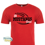 A red short-sleeve crewneck t-shirt with a two-color black and white football and the text Mustangs Dad running in the middle of the football.