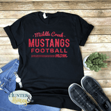 Black 100% cotton t-shirt with red glitter design that reads Middle Creek Mustangs Football Mom.