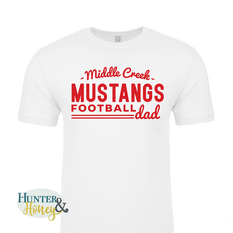 A white ringspun cotton crewneck tee with a red imprint reading Middle Creek Mustangs Football Dad across the chest.