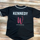 Black with white trim baseball jersey with player name and Wheaton Batton logo in pink and white glitter.