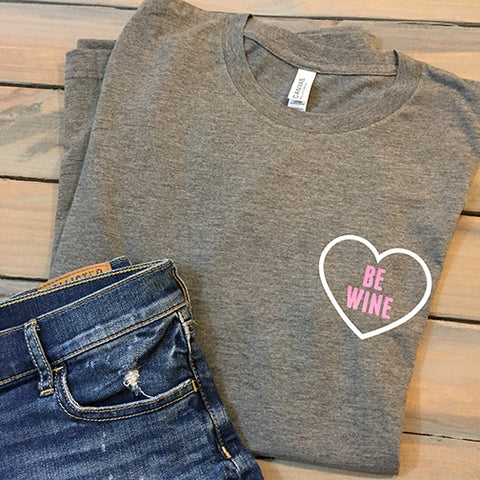 Grey Be Wine triblend graphic tee with a chest-size white heart and pink lettering. 