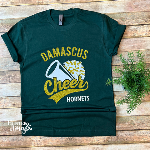 Hunter green Damascus Hornets cheer t-shirt with a gold and white glitter imprint.