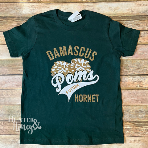 Damascus Poms Future Hornet hunter green t-shirt with a gold and white glitter design featuring PomPoms. 
