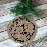 A 7" round natural cork trivet with black script happy holidays and vine and berries laurel border.