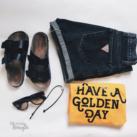 Have a Golden Day gold cotton tee with black text in a retro style.