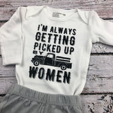 I'm Always Getting Picked Up by Women white long sleeve infant bodysuit with pickup truck.