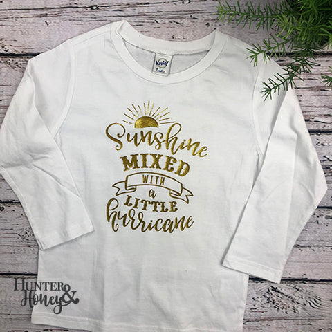 White long sleeve cotton tee with gold glitter Sunshine Mixed with a Little Hurricane design that is perfect for the crazy toddler in your life.